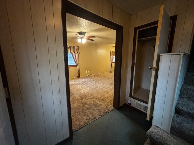Front door entry way, hall closet, stairs going up to 3 bedrooms. - 829 W 5th Ave