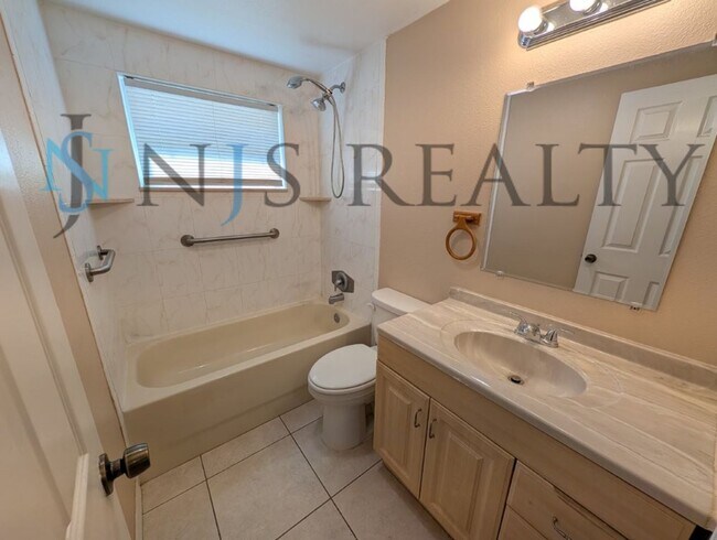 Building Photo - This 3/2/1 with over 1100 sq ft offers all tile floors open kitchen/dining, split floor plan on a...