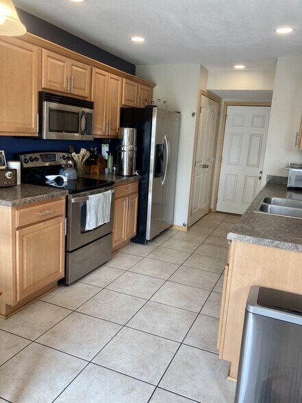 kitchen with garage access - 906 SE Crossings Ln