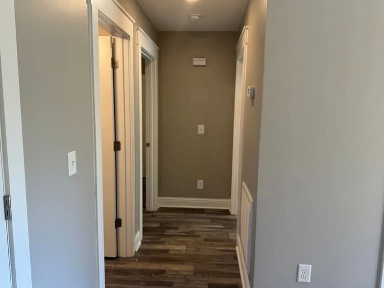 Hallway leading to two bedrooms and a bathroom - 111 Buster Ln