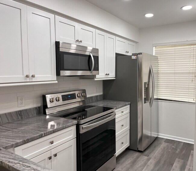 Building Photo - Two-story condominium, featuring 2 bedrooms and 2 1/2 bathrooms