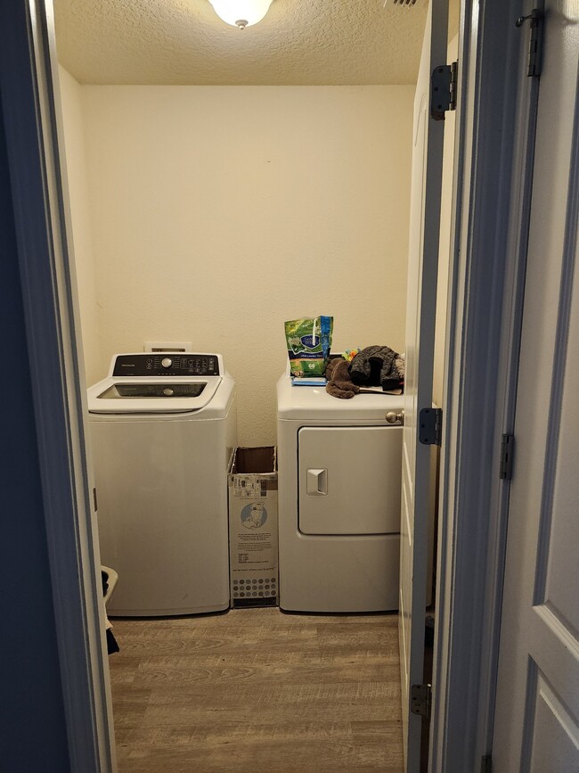 Separate laundry room includes a door which is great reducing noise. - 2142 Pebble Point Dr