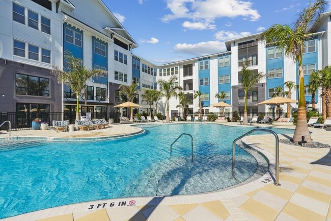 Resort-style pool with sun shelf, cabanas and grills for relaxing and entertaining close to home. - Forayna Watercolor Place