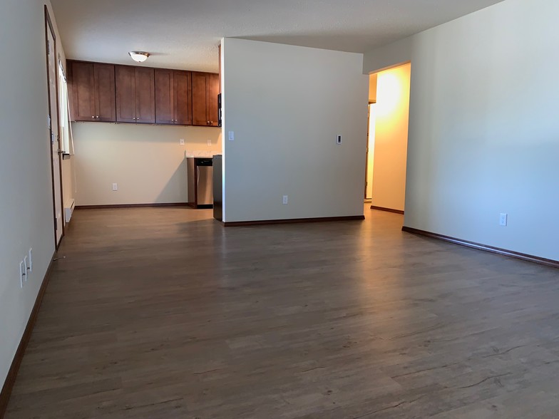 Large living room with plank floors! - Pearl Manor Apartments - 55+ Senior Living