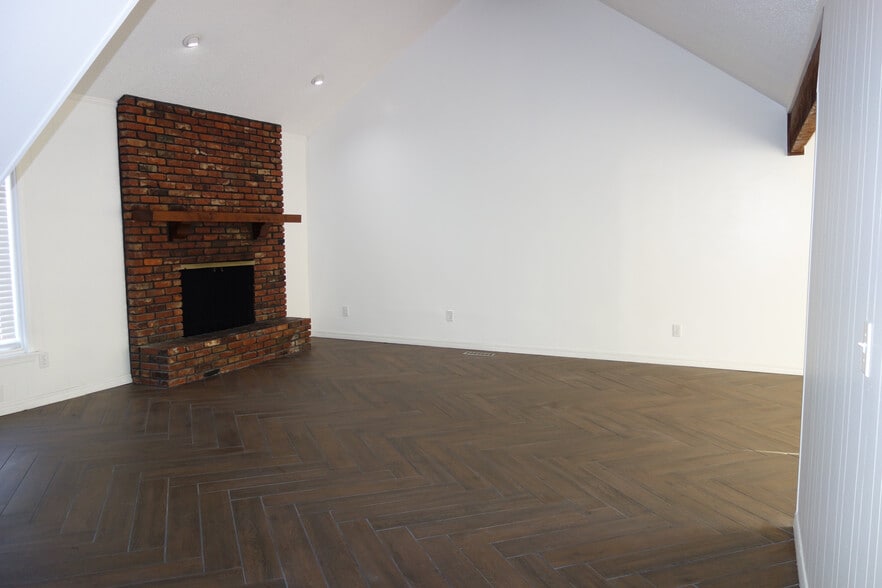 Living room with brick fireplace - 7116 S Indianapolis Ave