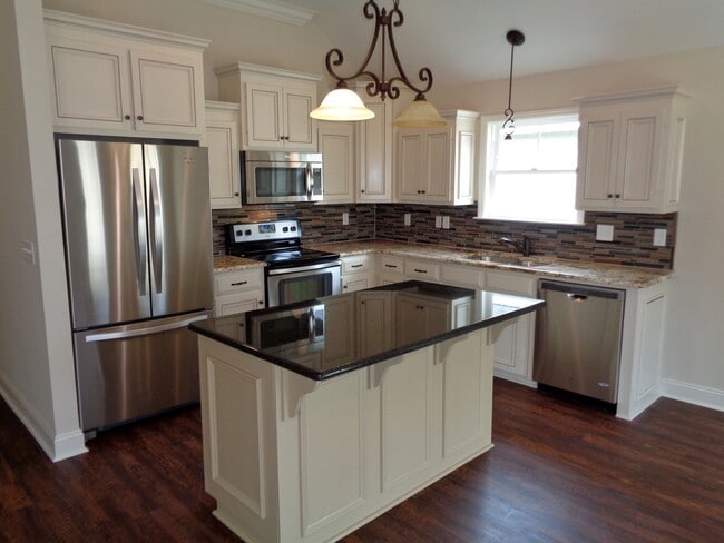 Building Photo - Spacious 4BR Home with Open Split Floor Plan, Granite Kitchen & Fenced Yard