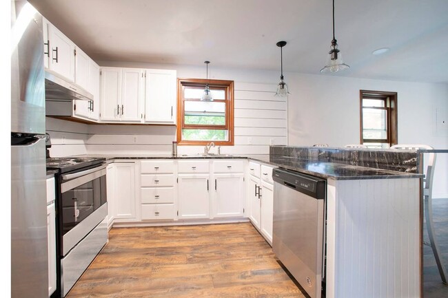 Kitchen with stainless steel appliances and granite countertops - 8 Virginia St