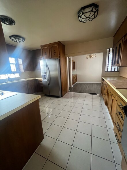 Stainless steel refrigerator. Double range oven and countertop stove. Separate dining area. - 881 Bishop Rd