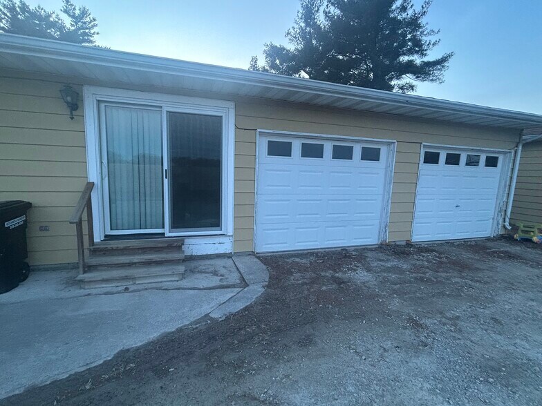 Outdoor patio area with attached garage door (left door) - 5672 Summer St