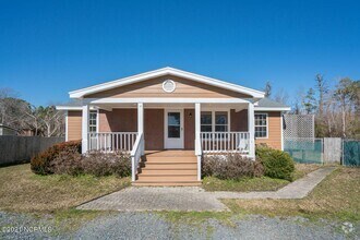 Building Photo - Southport Home With Fences In Yard