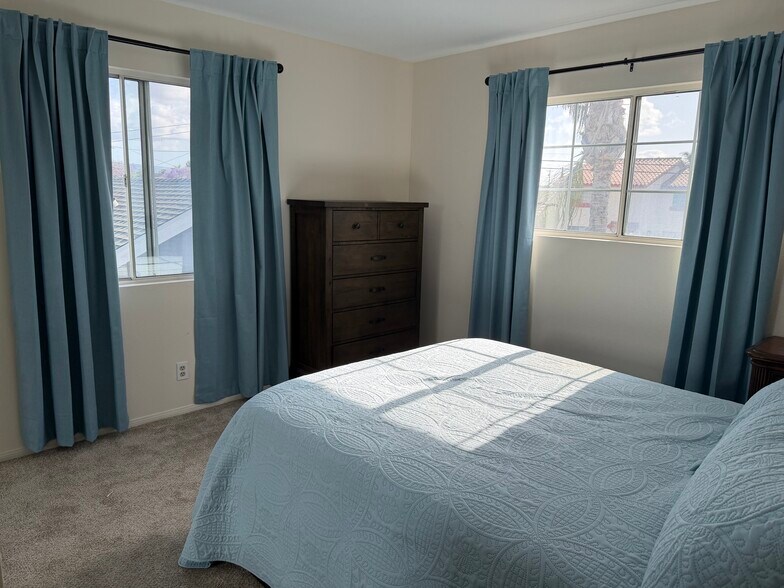 bedroom two with queen bed and dresser - 14902 Eastwood Ave