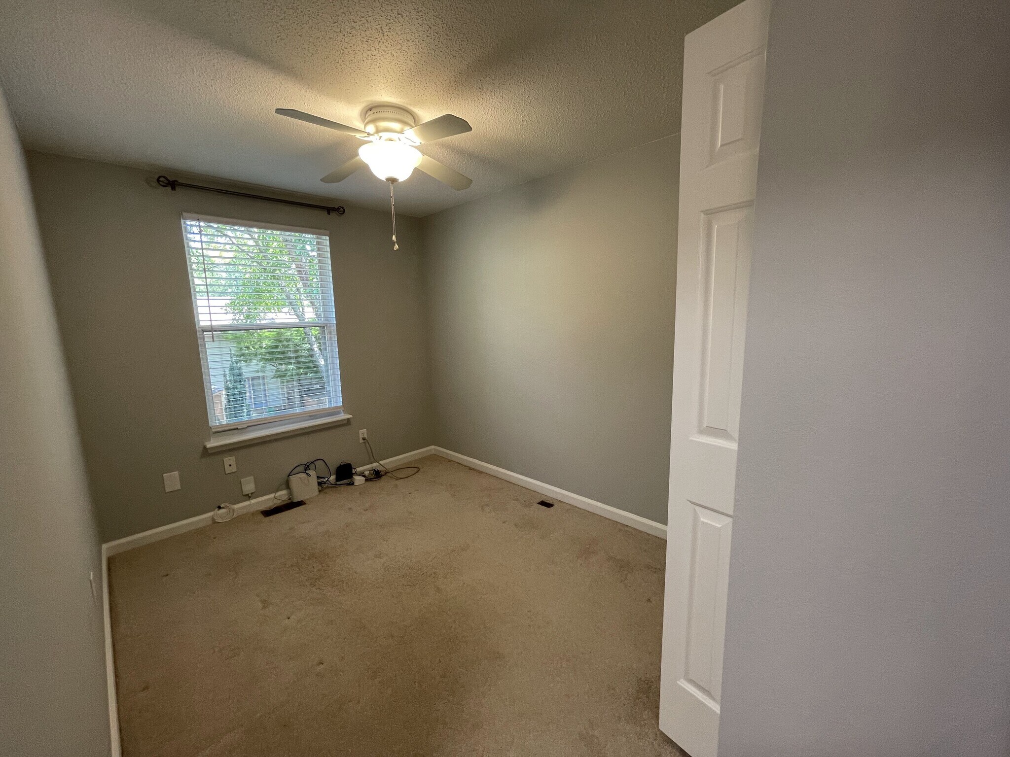 Third bedroom/office with ceiling fan, room darkening blinds, and curtain rod - 4204 Whistler Ct
