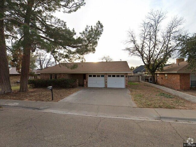 Old photo. Garage doors and metal fence have been added since purchase