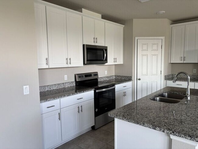 Building Photo - Like-New 4 Bedroom 3 Bath with Pond View & Two Living Spaces — Minutes to South Lake Nona
