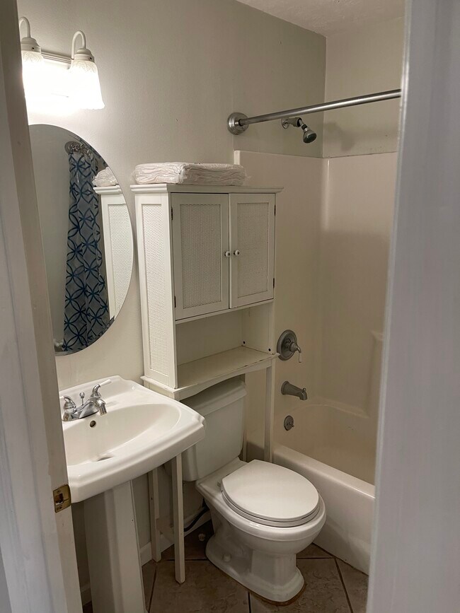 Full bath with shower and tub off kitchen downstairs. - 2931 Valley Rose Dr