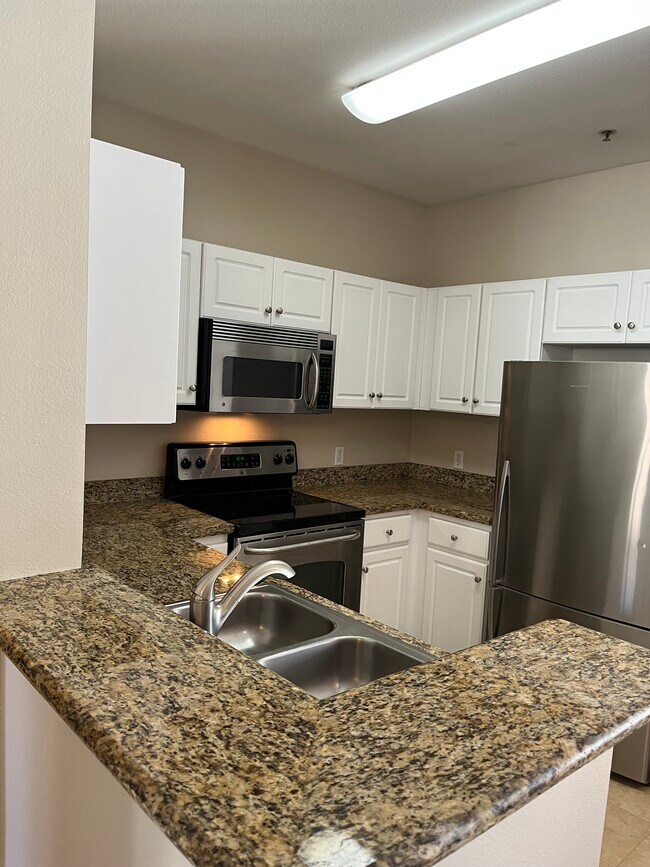 Kitchen and bar area - 8228 Station Village Ln