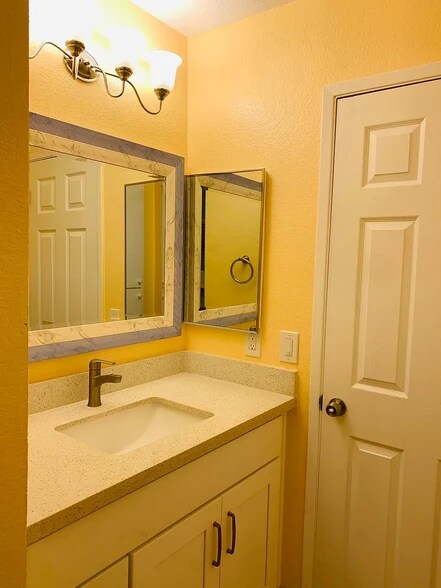 New vanity with quartz top, faucet, light, and mirror - 5318 Borneo Cir