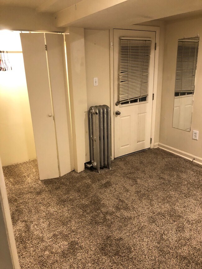 Empty small bedroom, with door to backyard. - 1710 Euclid St NW