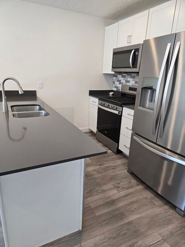 Building Photo - Nearly New, Well Appointed Modern Townhouse w 2 car attached garage