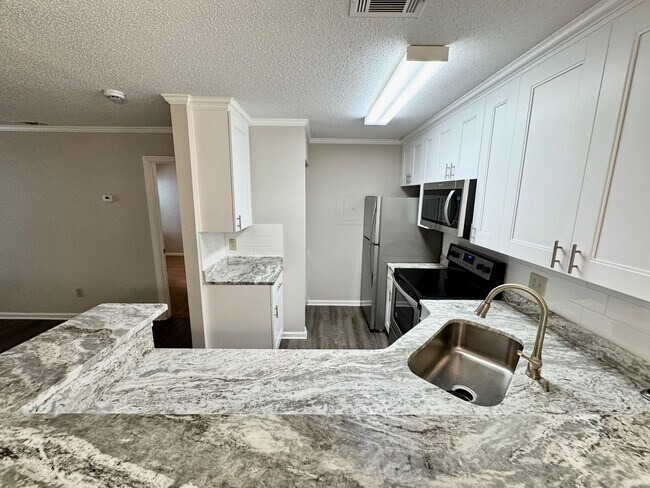 Building Photo - Updated 1st Floor/1-Level Condo Available NOW & Rent Includes Water, Sewer, Trash, Landscaping, F...