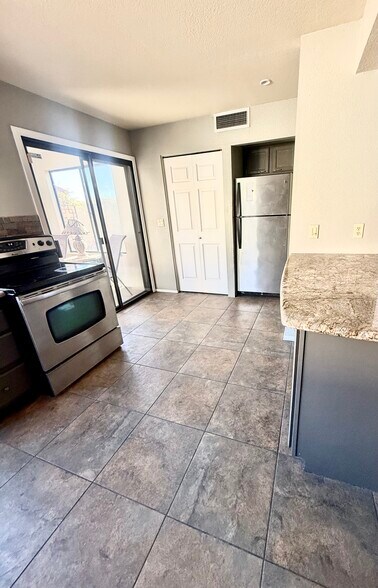 Washer and dryer next to fridge - 200 E Belcourte Pl