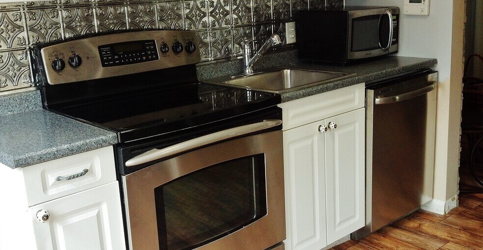 Accessorized Kitchen with stainless appliances. Glass sliders out to tree top deck! - 20 Elm Ave