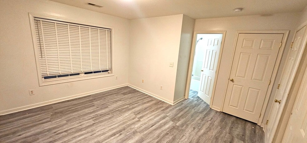 Large primary bedroom with new flooring - 7 Lotus Dr