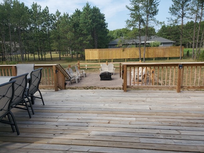 deck view out to large wood burning Fire Pit - 1314 Bogey Trl