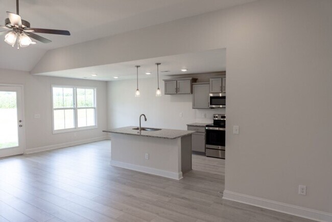 Building Photo - Modern Living Redefined with Stone Fireplace, Gray Cabinetry, Spa Inspired Primary Suite and Cove...