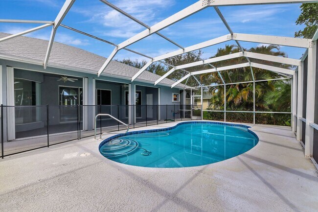 Building Photo - A BOATER'S PARADISE WITH THIS STUNNING 3 BEDROOM, 2 BATH WATERFRONT POOL HOME W/DOCK & BOAT LIFT ...