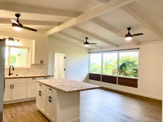 Beautiful views of the greenery of the backyard from the kitchen and living area's large windows - 81-1061 Captain Cook Rd