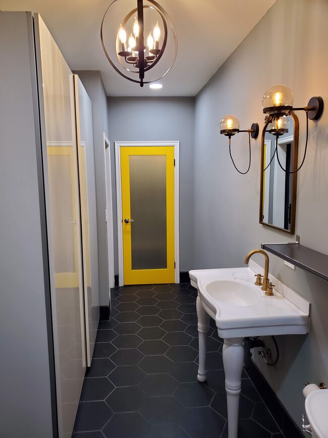 Spa-like bathroom with walk-in closet with canary-yellow accent door and separate linen closet to the side. - 579 W. 13th St