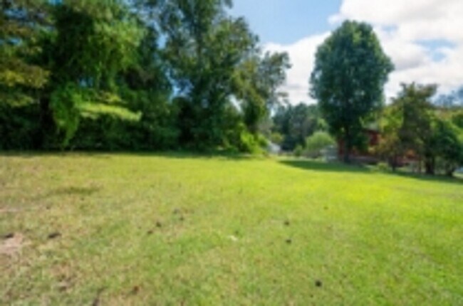 Building Photo - This beautifully updated brick home in Har...