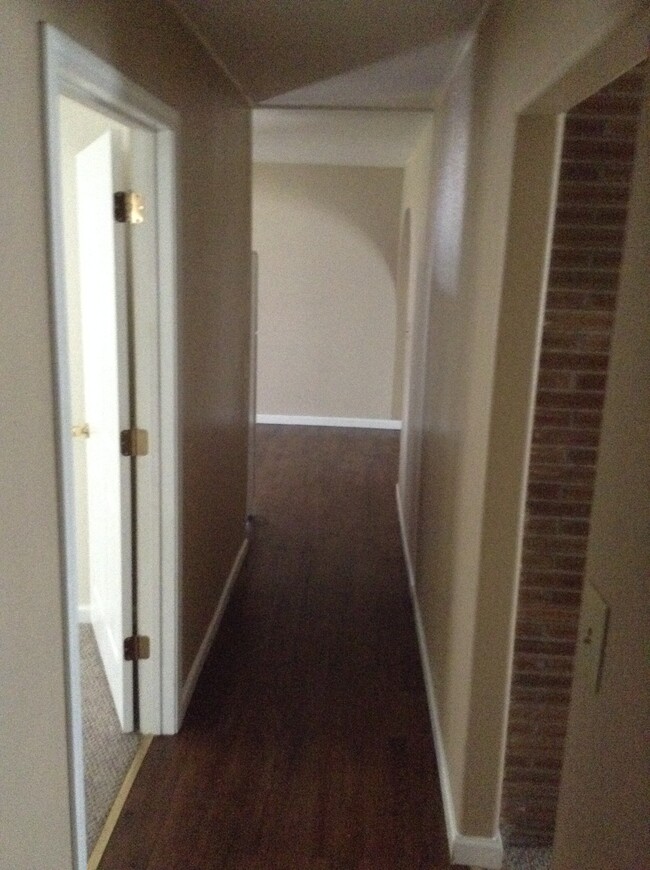 A look down the main hallway from the other direction with the living room to the right and the kitchen and master bedroom to the left. - 24 N K St