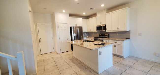 Building Photo - Beautiful townhome features a bright, open-concept layout