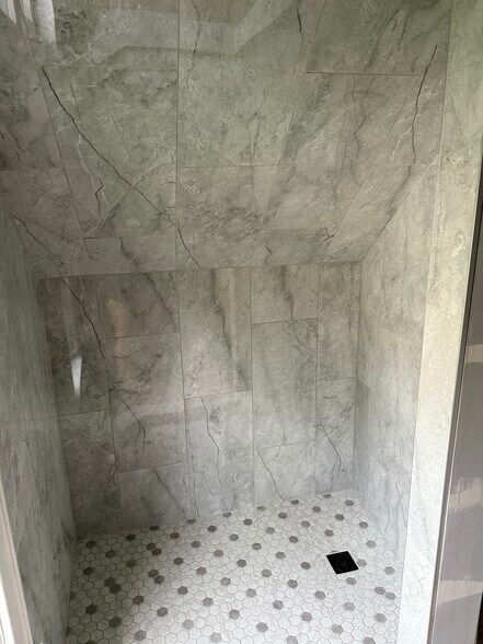 Tiled shower with hand held sprayer - everything updated in the bathroom - N89W15958 Main St