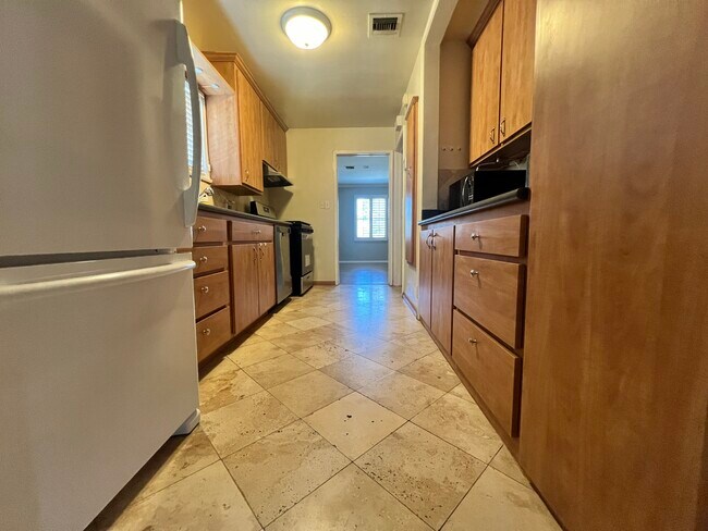 kitchen with stainless appliances and bonus fridge, microwave etc. - 14340 Hatteras St