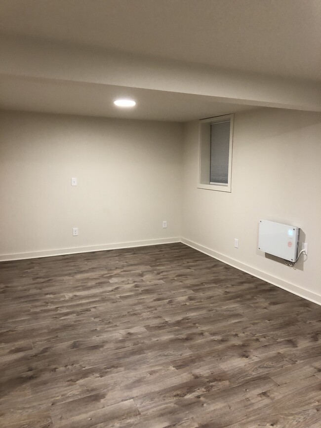 Large living/bedroom area with closet. Large egress window and another window bring a ton of light. Window coverings for privacy. - 4842 NE Mallory Ave