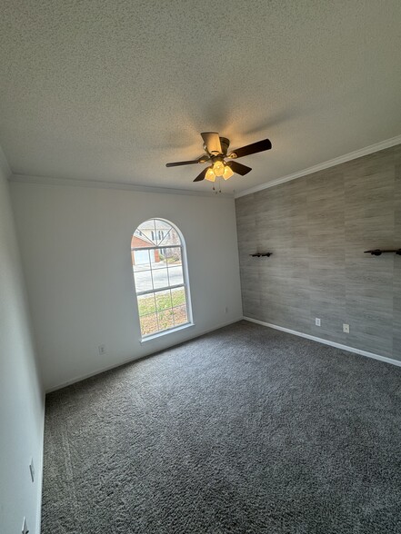 Front bedroom/office on left side of condo with view of front yard/parking area. - 1701 Water Oak Dr