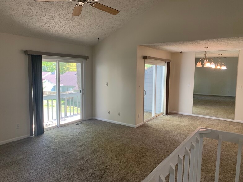 Living room view of dual door wrap around deck. - 197 Sugarwood Ln