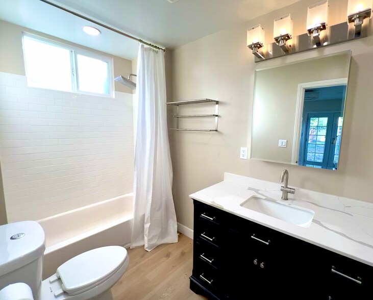 The primary ensuite bath has a tup, rain showerhead and spacious vanity. - 2824 S Orange Dr