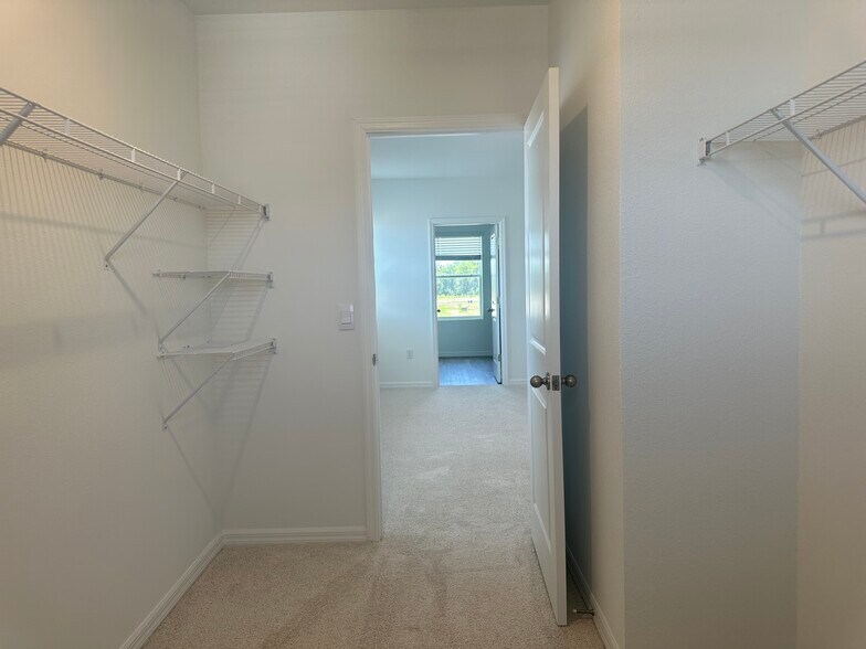 Primary closet to bedroom to bathroom - 10574 Dusty Boot Rd