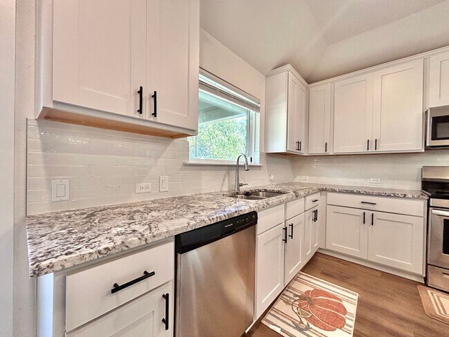 Building Photo - Inviting 4-Bed, 2.5-Bath Home with High Ceilings and Covered Deck