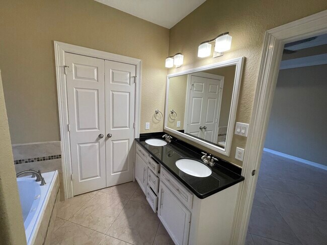 Master bathroom leading to walk in closet - 600 River Bend Dr