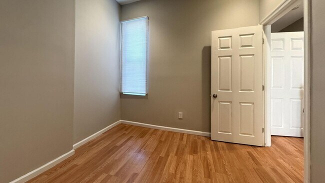 Building Photo - Charming 4BR/2BA Rowhouse with Hardwood-Style Flooring Throughout