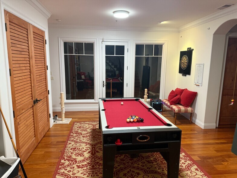 Downstairs game room: Game room with a ping pong table, pool table, air hockey, regulation darts - 115 Inez Pl