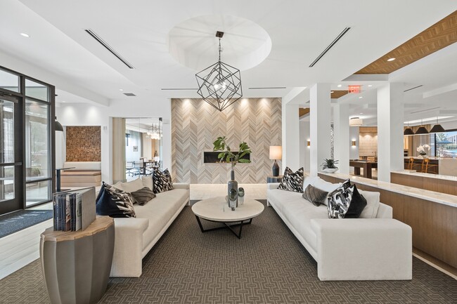 Resident lobby with ample seating, fireplace and flexible coworking space - Hanover Crossing Residences