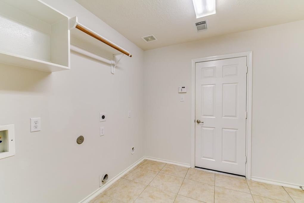 Laundry room with garage entrance - 8310 Coriander Ln