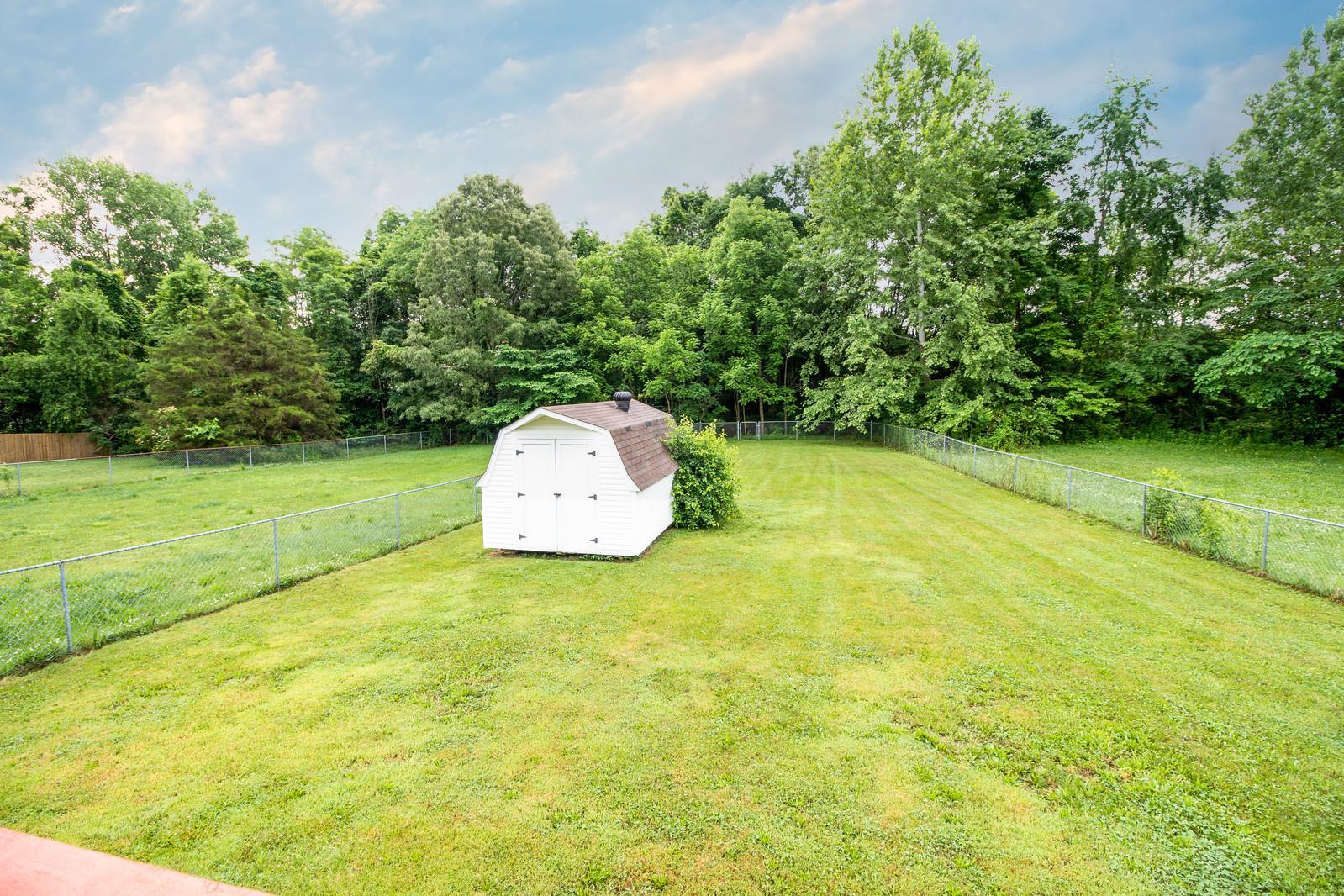 Oversized fenced yard with storage shed (wired for electricity) - 1805 Colt Dr