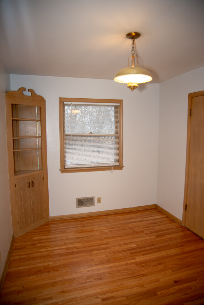 Main floor bedroom with built in cabinet and closet for extra storage. - 1911 Talmage Ave SE